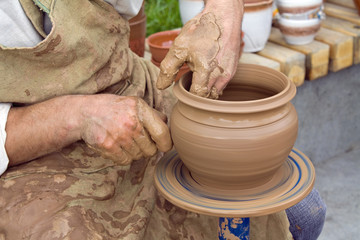 Potter hands and spinning potter's wheel