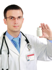 Friendly medical doctor with blank pill's bottle. Isolated