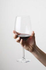 Hand holding a glass of red wine