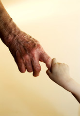 hand of grandmother and grandchild
