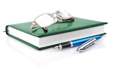 green notebook with pen isolated on white