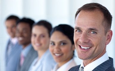 Fototapeta premium Attractive businessman in a row with his team