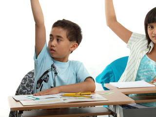 children in the classroom, raising hands