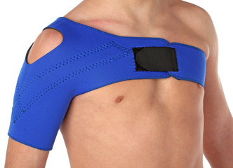 Patient wearing a shoulder bandage, over white