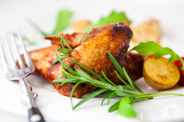 Roasted chicken wings with herbs and baked vegetables