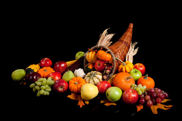 Fall arrangement of fruits and vegetables in a cornucopia