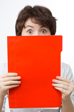 Amazed businesswoman with red file.