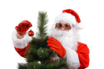 santa claus in shades decorating a christmas tree