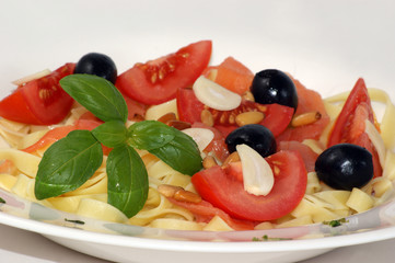 garlic, olive, tomato and pasta with organic basil leaf