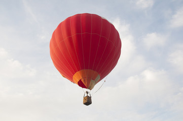 Colorful air balloon flies high in the sky