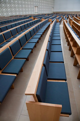 Photo of an empty auditorium with blue seats.