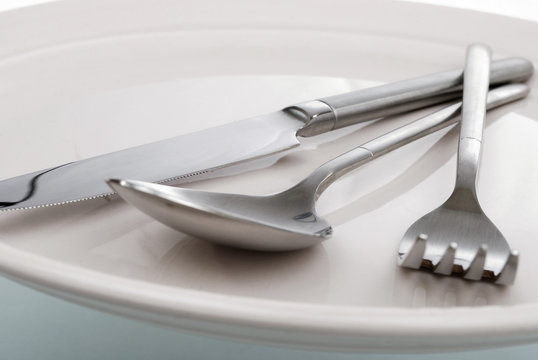 empty plate, fork, spoon and table-knife