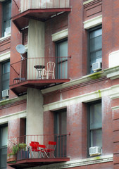 Balcony with red chairs
