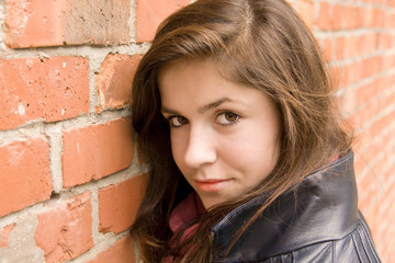 beautiful young girl lean on red brick wall 2
