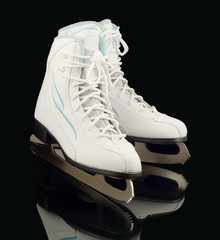 Pare of figure skates on a black background