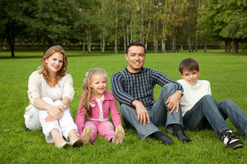 Fototapeta premium happy family of four persons outdoors