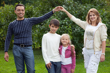 Fototapeta premium parents playing with children in park