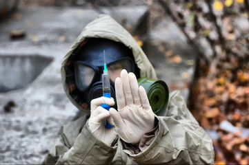 person in gas mask with syringe