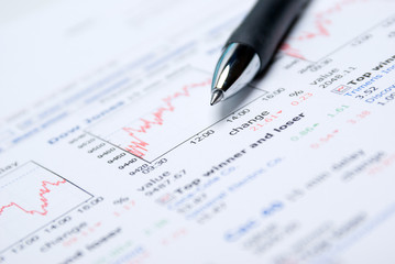 Business accessories on a background of diagrams.