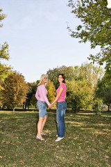 Fototapeta premium two sisters walking hand to hand