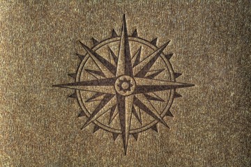 Compass rose on wood texture