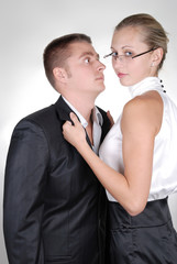 a woman holding neckband of a man with passion