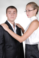 a woman putting her arms on the shoulders of aman