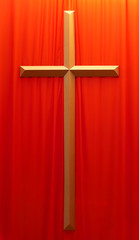 golden crucifix on a red fabric background