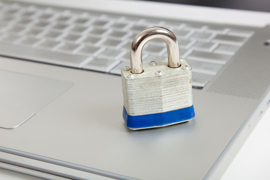 A silver padlock on a computer