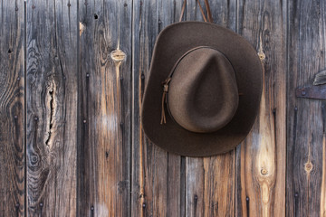 felt cowboy hat on barn wall