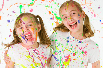 Happy and Messy children covered in paint