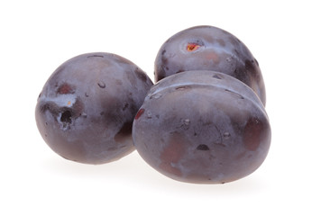 Three plums on white background