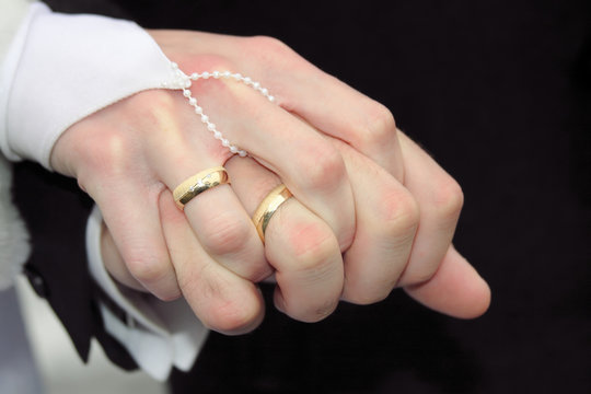 Hand of the groom and the bride with wedding rings