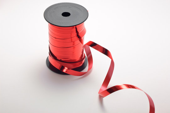 Red ribbon and spool