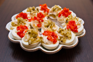 eggs with cucumber and red pepper with mayonnaise on the plate