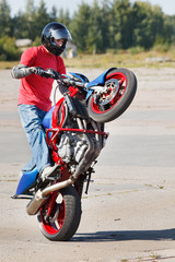 Stunt rider making wheelie