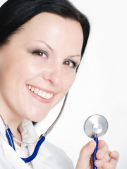 closeup of smiling brunette female doctor holding stethoscope