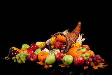 Fall arrangement of fruits and vegetables in a cornucopia