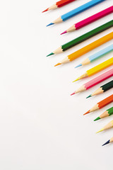 Many colour pencils isolated on white