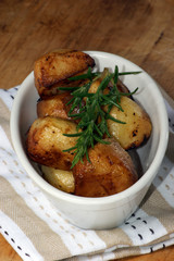 organic rosemary roasties in a white bowl