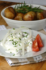 young herring in yogurt sauce on a white plate