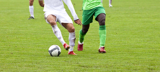 Soccer players fighting for the ball
