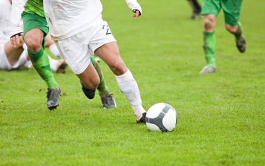 Soccer players fighting for the ball
