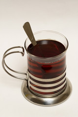 Glass of black tea with steel glass holder