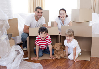 Fototapeta na wymiar Family moving house with boxes around
