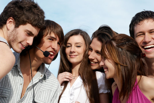 Group of young guys and girls having fun on the nature