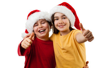 Kids wearing Santa Claus hats showing OK sign , isolated