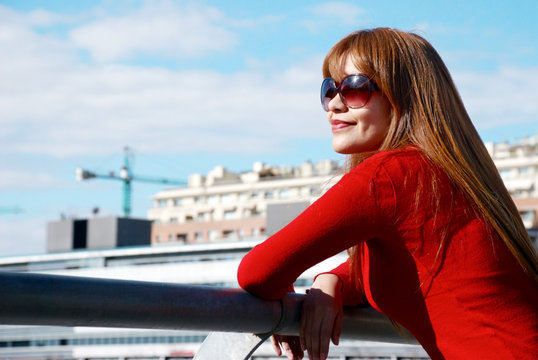 woman in sunglasses on a city background