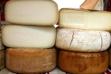 Aged french cheese wheels stacked