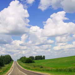 Road,green field and blue sky.